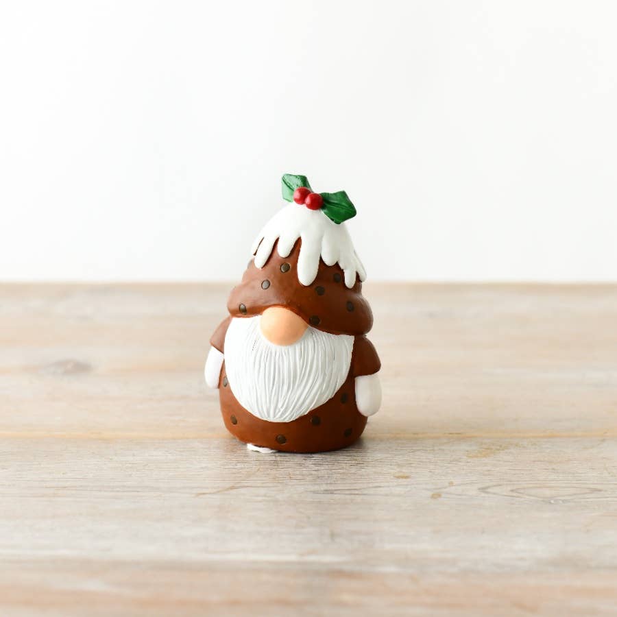 Gnome figurine with a cake hat on a wooden surface