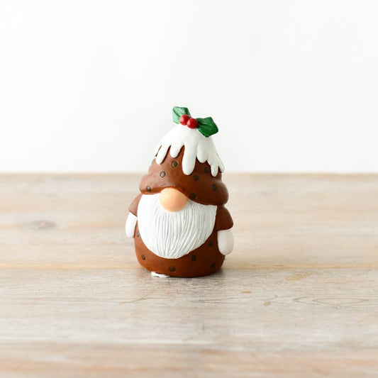 Gnome figurine with a cake hat on a wooden surface