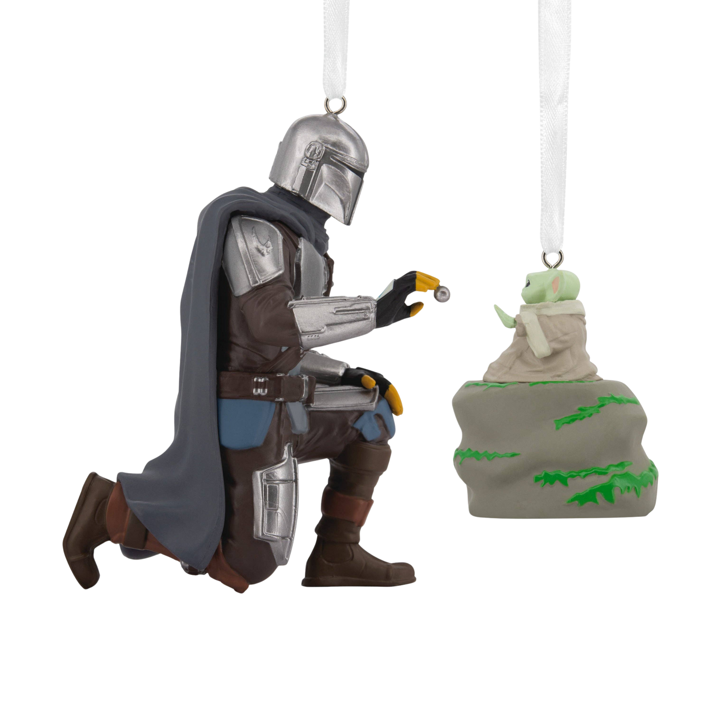 Two Christmas Star Wars ornaments of the Mandalorian kneeling and Grogu sitting on a rock.