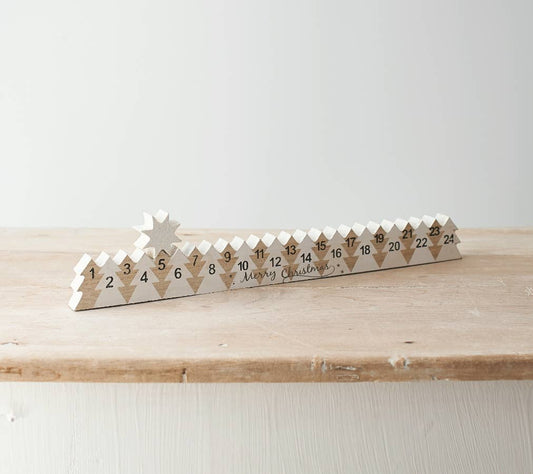 Wooden advent calendar with diamond patterns on a wooden surface